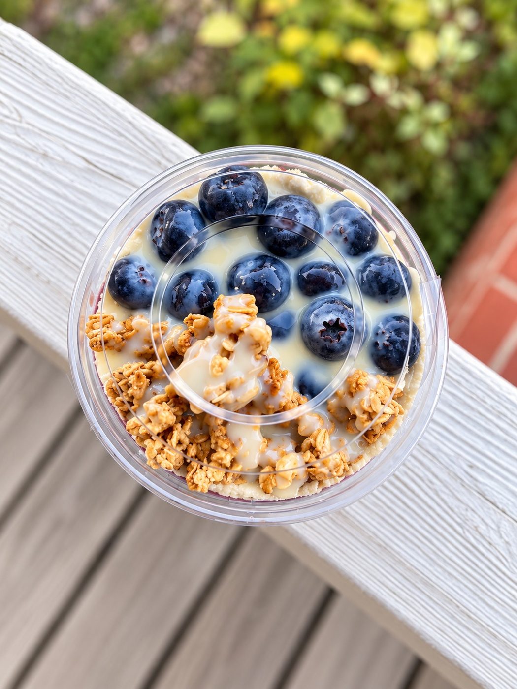 Açaí bowl with strawberries, blueberries and granola at golden hour